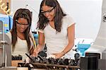 Engineering students working with tools in a laboratory