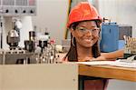 Engineering student studying in a machine lab