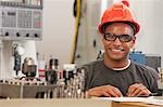 Engineering student studying in a machine lab