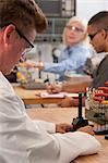 Engineering professor installing CNC machine tool in the tool holder