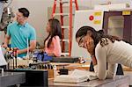 Engineering students working in a CNC machine lab