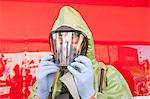 Close-up of a HazMat firefighter putting on mask