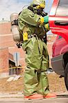 HazMat firefighter getting supplies from a truck