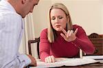 Woman signing the word 'Fly' in American Sign Language while looking at a map