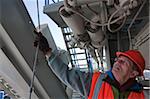 Engineer examining insulated liquid delivery pipe