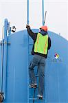 Engineer climbing on a diesel tanker