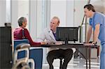 Doctor and male nurse consulting with a patient