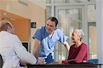 Doctor and male nurse consulting with a patient