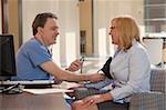 Male nurse measuring a patient's blood pressure