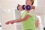 Seniors exercising with dumbbells in a health club