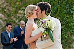 Newlyweds kissing at marriage ceremony