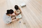 Mother and daughter with newspapers, high angle