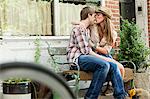 Young couple kissing on bench