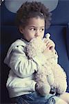 Little girl holding stuffed toy, portrait