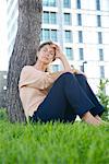 Woman sitting in grass resting