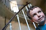 Boy at bottom of spiral staircase, portrait