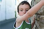 Boy preparing to climb stone wall