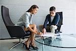 Businessman assisting businesswoman in signing document