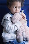 Little girl holding stuffed toy, portrait