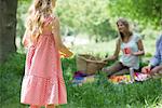 Little girl having picnic with family