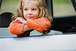 Little girl looking out car window, portrait