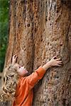 Girl embracing tree