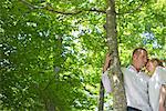 Couple embracing by tree