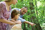 Family outdoors together, looking over railing