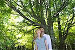 Couple in woods, looking up