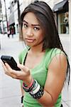 Unimpressed Woman Holding Cell Phone