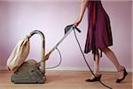 Woman Wearing Dress Using Electric Sander on Hardwood Floor