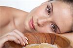 Woman laying by bowl of sugar