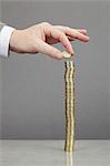 Businessman making stack of coins