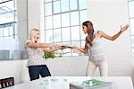 Businesswomen fighting over papers