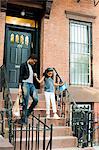 Mother and daughter leaving house