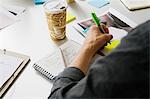 Young man writing on adhesive note