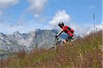 Boy Riding Bicycle in Mountains, Alps, France