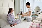 Man bringing wife breakfast in bed