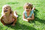 Young brother and sister lying on grass