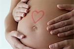 Couple's hands on woman's pregnant belly