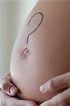 Question mark drawn on woman's pregnant belly