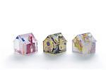 Model houses folded with different currencies