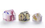 Model houses folded with different currencies