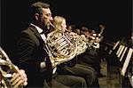 French horn players in orchestra