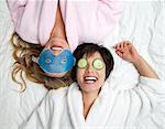 Women in bathrobes wearing eye masks