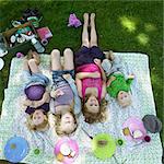 Children laying on picnic blanket