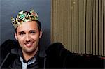 Smiling man wearing plastic crown