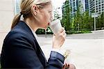 Businesswoman with coffee and sandwiches