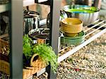 Utensils and basket in rack in garden