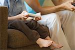 Father and son playing video game together, cropped